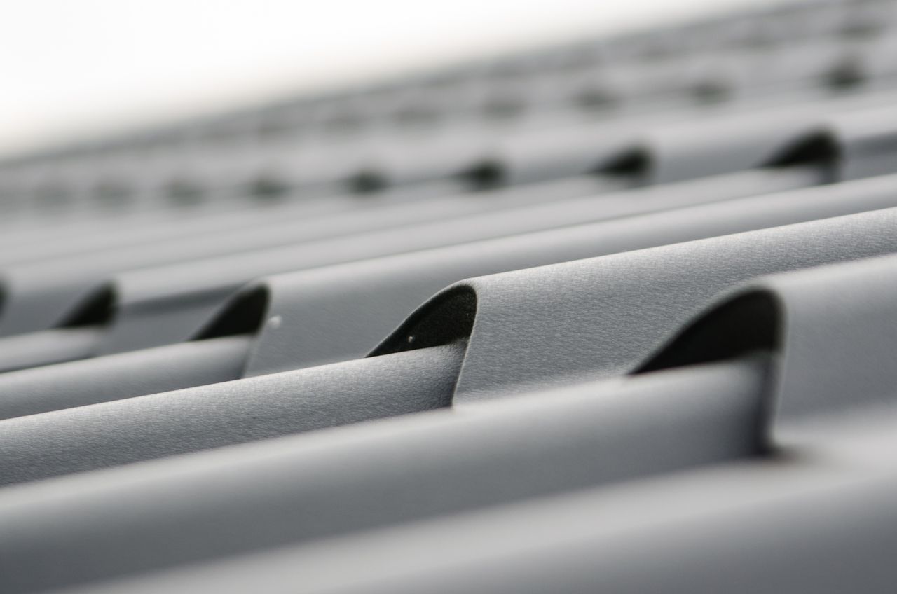 The Art of Drawing Readers In: Your attractive post title goes here Detailed close-up of grey metal roof sheets showcasing texture and design.
